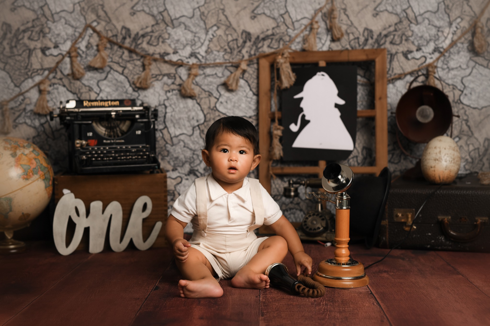 First birthday portrait in a vintage detective-themed décor